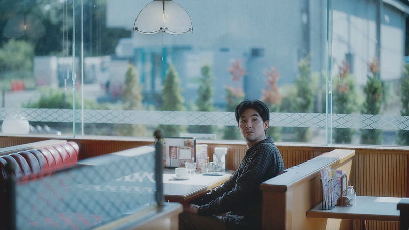 香川照之　不安にも必死にも見える表情で窓ガラスをホースで清掃する姿　「災 劇場版」場面写真